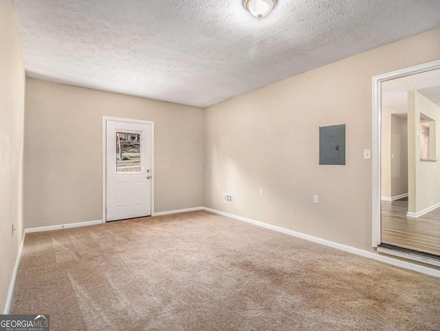 2887 Rockcliff Rd SE, Atlanta, GA 30316 - empty room featuring electric panel, carpet floors, a textured ceiling, and baseboards
