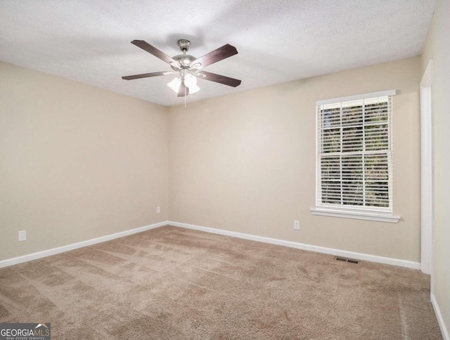 2887 Rockcliff Rd SE, Atlanta, GA 30316 - carpeted empty room with a ceiling fan, baseboards, healthy amount of natural light, and a textured ceiling