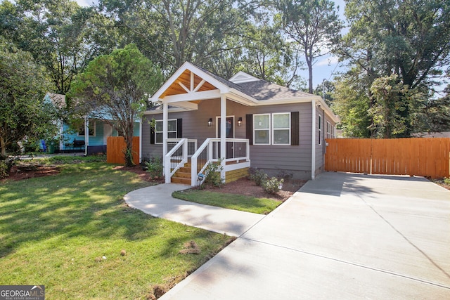 bungalow-style home with a front yard