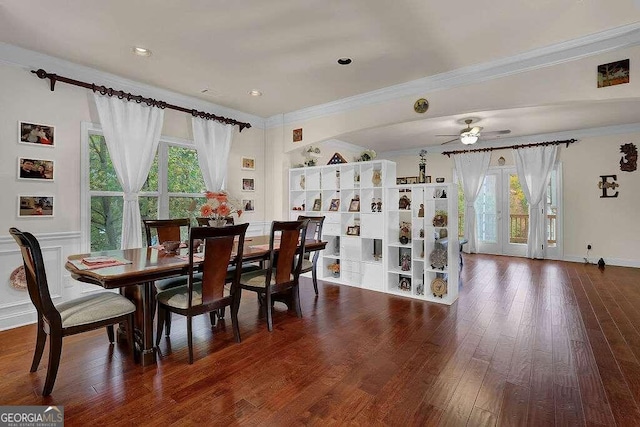 dining room featuring ornamental molding, dark hardwood / wood-style flooring, and a healthy amount of sunlight