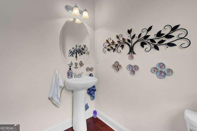 bathroom with wood-type flooring and toilet