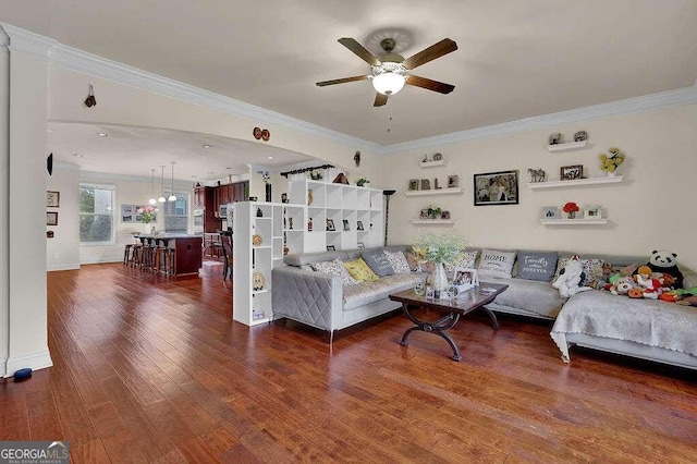 living room featuring ceiling fan, dark hardwood / wood-style floors, and ornamental molding