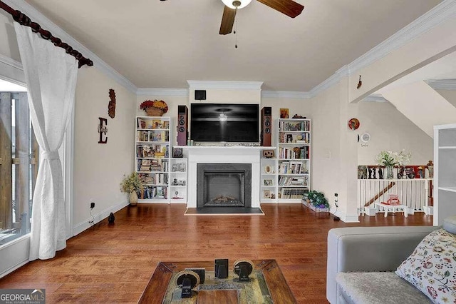 living room with hardwood / wood-style floors, ceiling fan, and ornamental molding