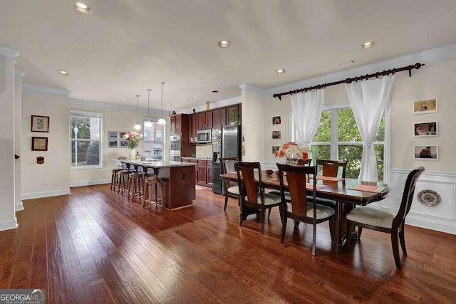 dining space with dark hardwood / wood-style floors and ornamental molding