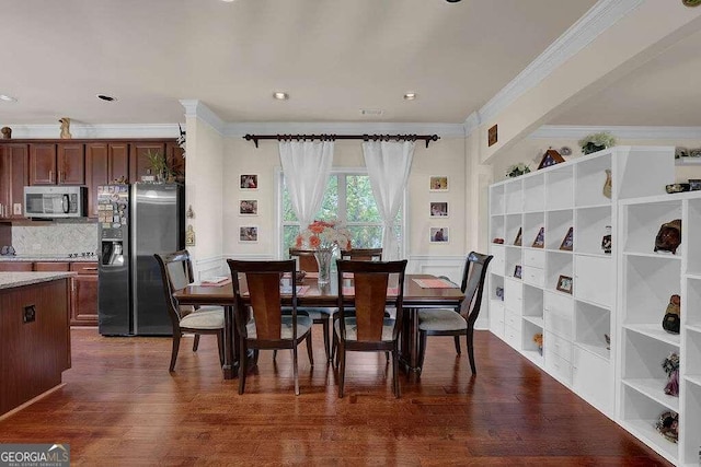 dining space with dark hardwood / wood-style floors and crown molding