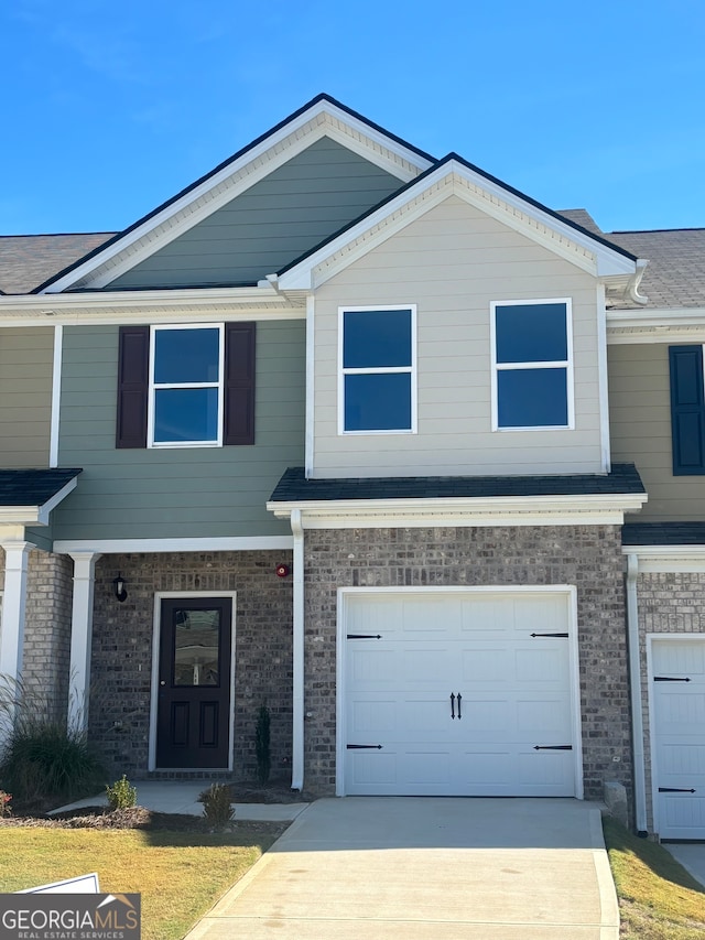 townhome / multi-family property featuring a garage