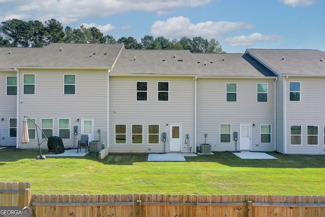 rear view of house featuring central AC unit, a patio area, and a yard