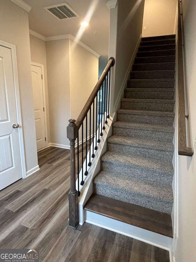 staircase featuring hardwood / wood-style flooring and ornamental molding