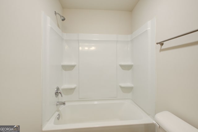 bathroom featuring toilet and washtub / shower combination