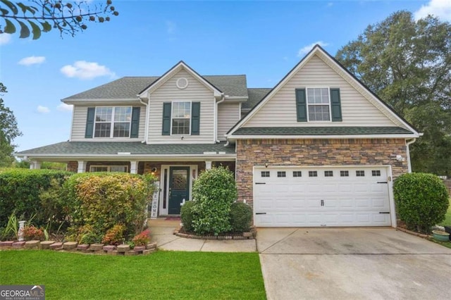 view of front property with a garage and a front lawn