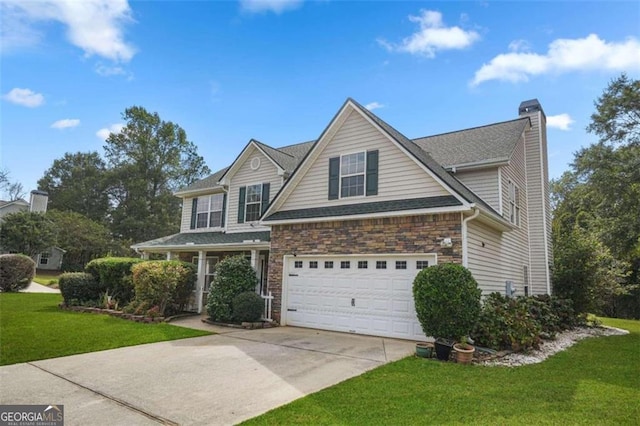 view of front of home with a garage and a front lawn