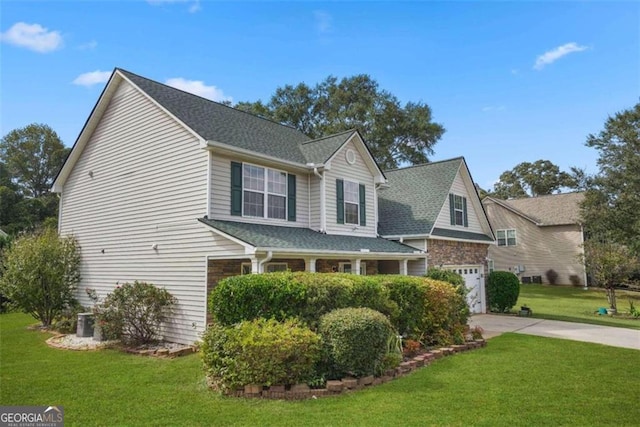 view of front of home with a garage and a front lawn