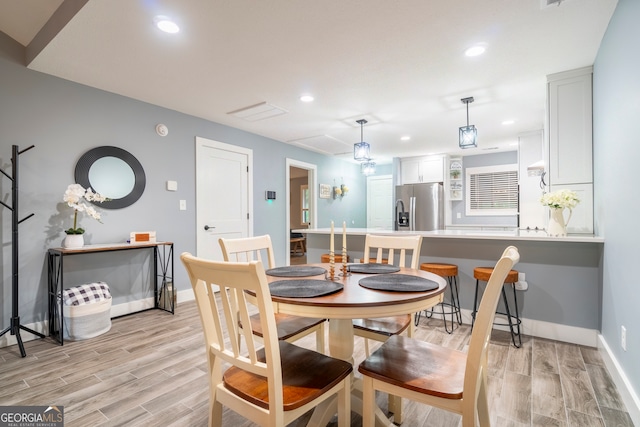 dining space with light hardwood / wood-style flooring