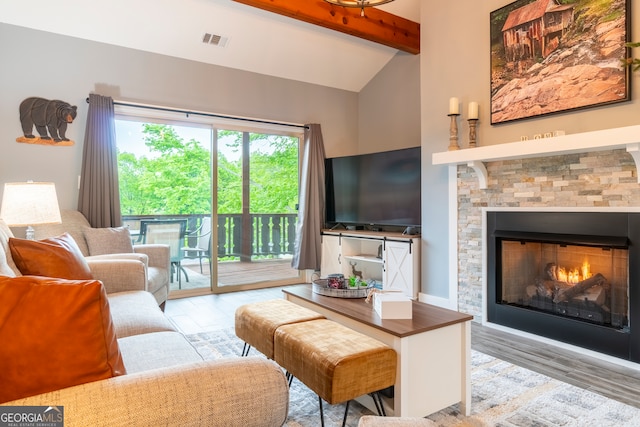 living room with vaulted ceiling with beams and light hardwood / wood-style floors