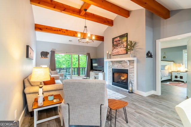 living room with a notable chandelier, vaulted ceiling with beams, a stone fireplace, and wood-type flooring