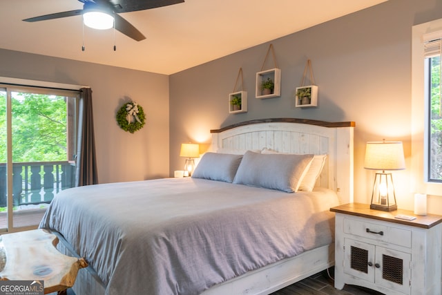 bedroom with ceiling fan, access to exterior, dark wood-type flooring, and multiple windows