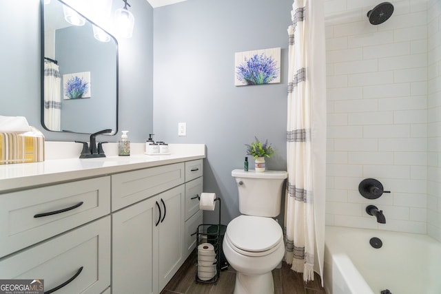 full bathroom with hardwood / wood-style floors, vanity, shower / bath combination with curtain, and toilet