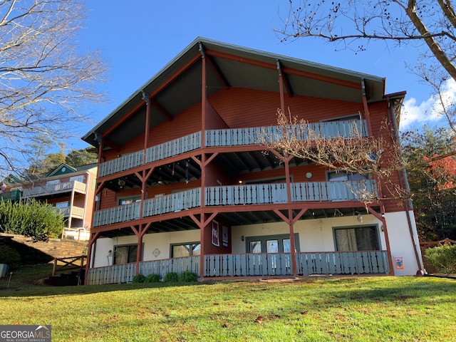 back of property featuring a lawn