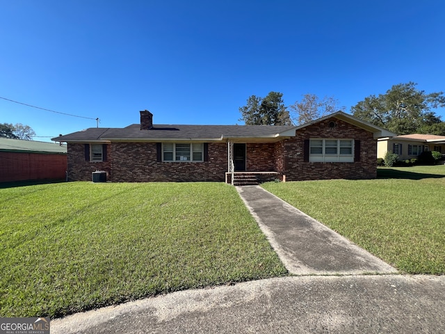 single story home with a front lawn and central AC unit