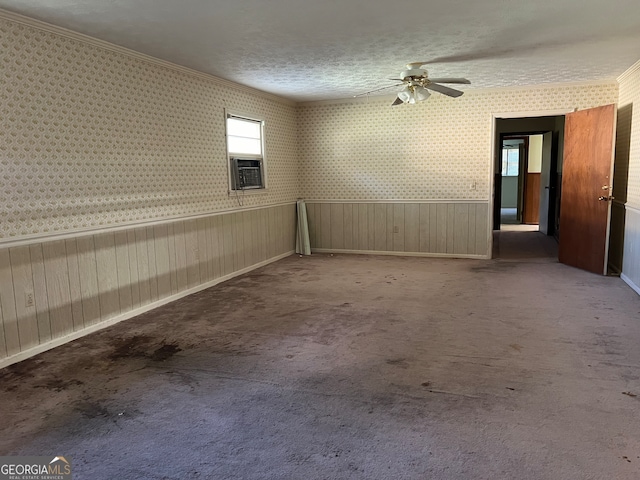 carpeted spare room featuring cooling unit, crown molding, ceiling fan, and a textured ceiling