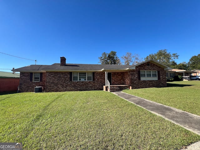 ranch-style home featuring central air condition unit and a front yard