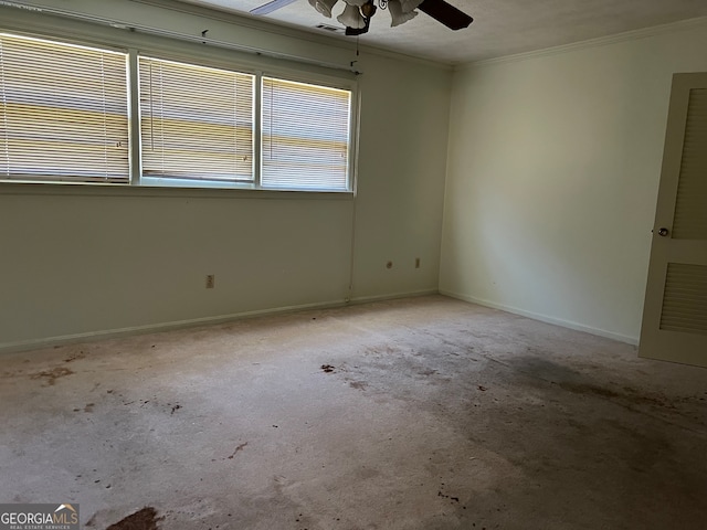 empty room with light colored carpet, ceiling fan, and ornamental molding