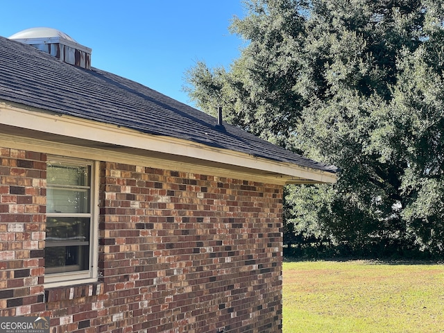 view of side of home with a lawn