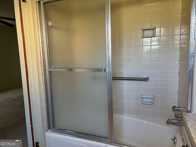 bathroom featuring bath / shower combo with glass door