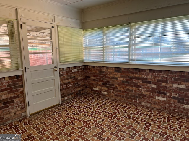 interior space featuring brick wall