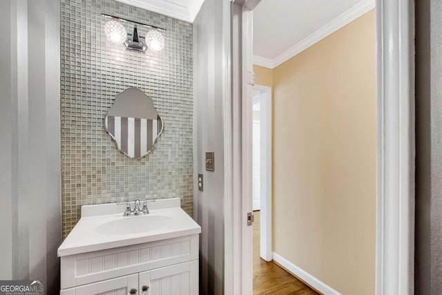 bathroom featuring vanity, hardwood / wood-style flooring, tile walls, and ornamental molding