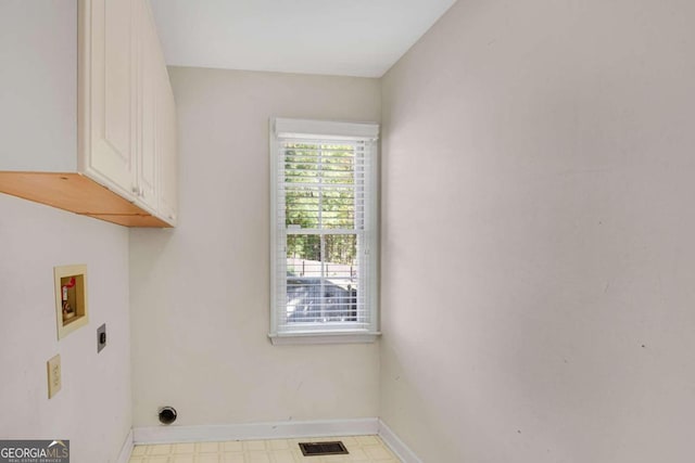 laundry room with electric dryer hookup, cabinets, and washer hookup