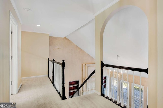 stairs with a chandelier, carpet floors, and lofted ceiling