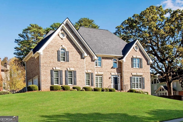 view of front of home featuring a front yard and a garage