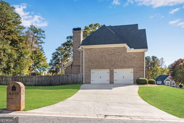 view of front facade with a front yard and a garage