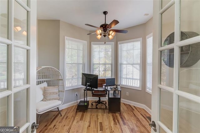 office space with french doors, light wood-type flooring, and ceiling fan