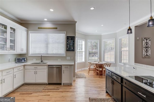 kitchen featuring dishwasher, pendant lighting, light hardwood / wood-style flooring, and white cabinetry