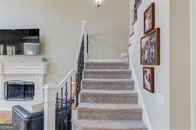 stairs featuring hardwood / wood-style floors