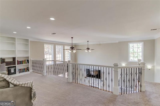 living area with carpet, ceiling fan, and ornamental molding