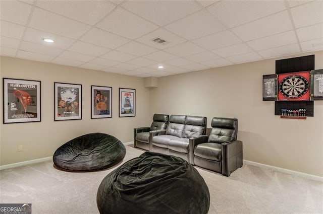 cinema with carpet flooring and a paneled ceiling