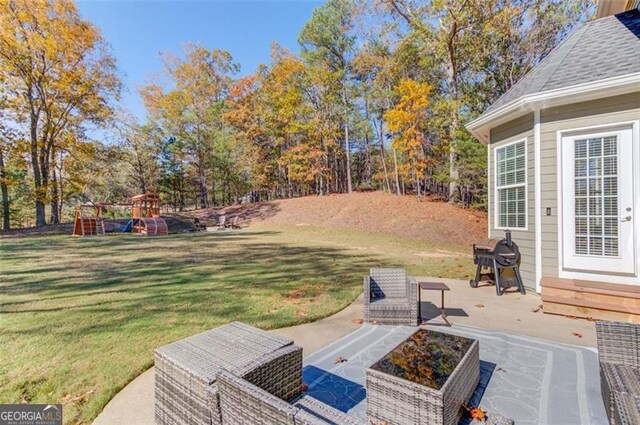 view of yard featuring a patio area and a playground