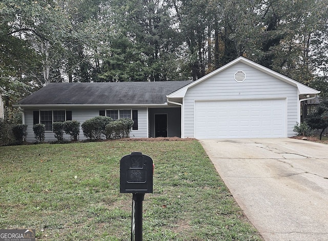 ranch-style house featuring a garage and a front lawn