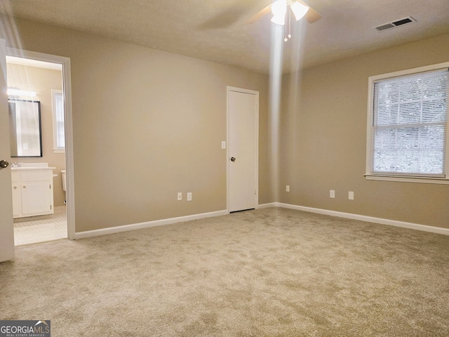 empty room featuring light carpet and ceiling fan