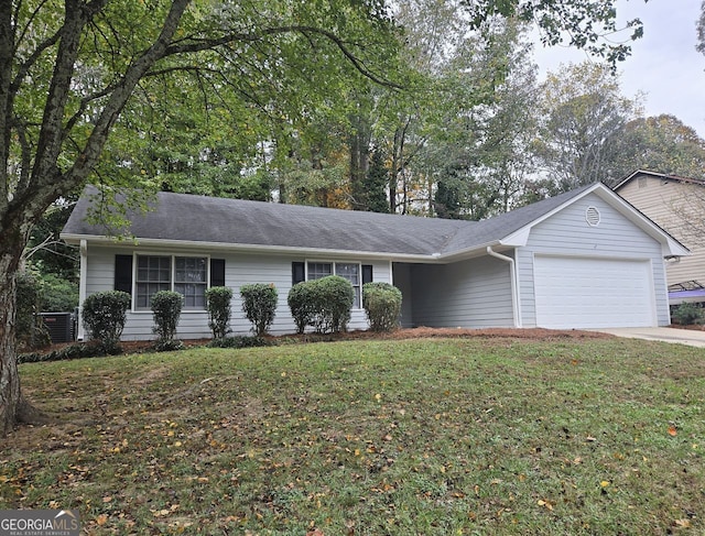 ranch-style home featuring a garage and a front lawn