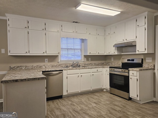 kitchen featuring white cabinets, stainless steel appliances, a textured ceiling, and sink