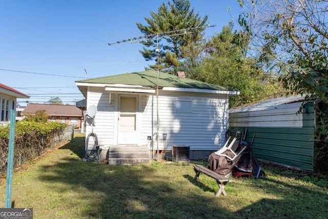 rear view of house featuring a lawn