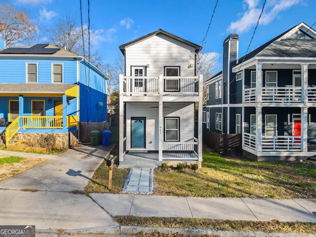 view of front of house with a front yard and covered porch