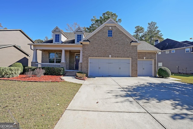 view of front facade with a front lawn, covered porch, and a garage