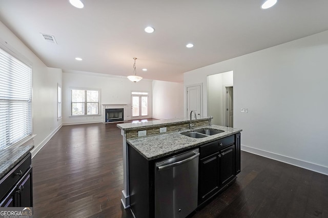 kitchen with stainless steel dishwasher, sink, pendant lighting, dark hardwood / wood-style floors, and an island with sink