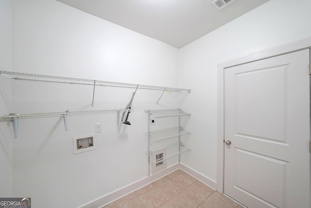 laundry room with hookup for a washing machine and light tile patterned flooring