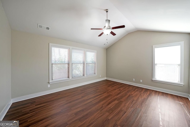 spare room with ceiling fan, dark wood-type flooring, and lofted ceiling